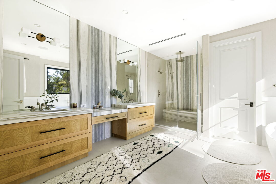 6310 Mirror Lake Drive Los Angeles, CA 90068 - Photo 17 of 34 a large white bathroom with a granite countertop sink mirror and a bathtub