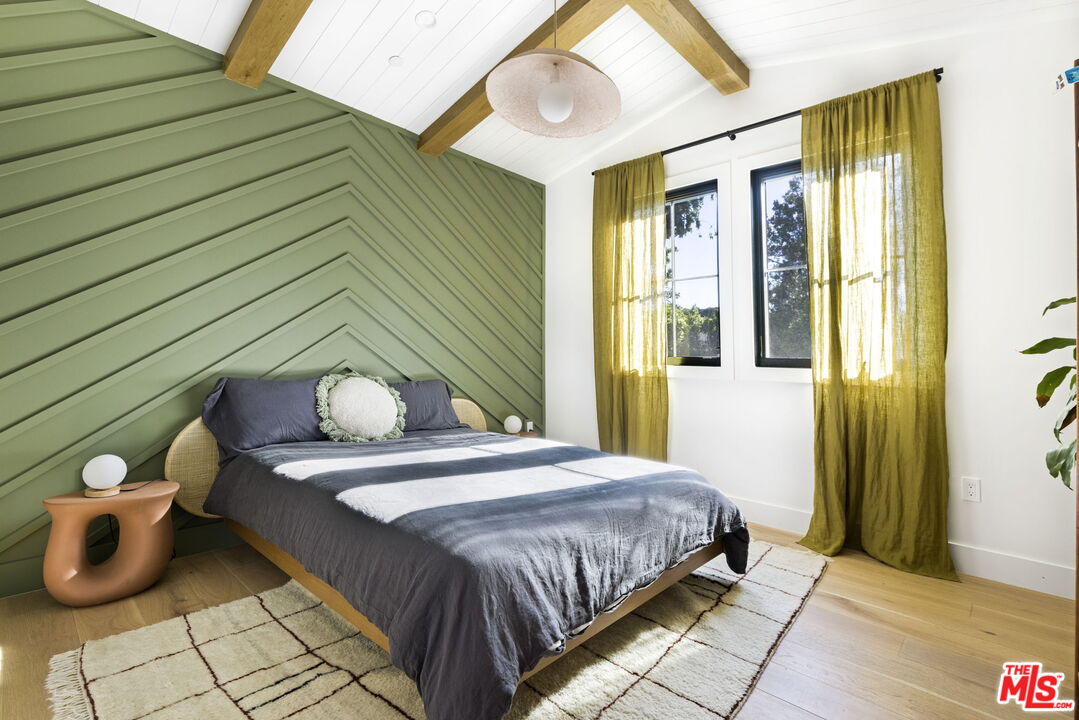 6310 Mirror Lake Drive Los Angeles, CA 90068 - Photo 21 of 34 a bedroom with a bed and wooden floor