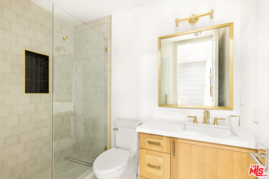 6310 Mirror Lake Drive Los Angeles, CA 90068 - Photo 22 of 34 a bathroom with a granite countertop sink toilet and shower