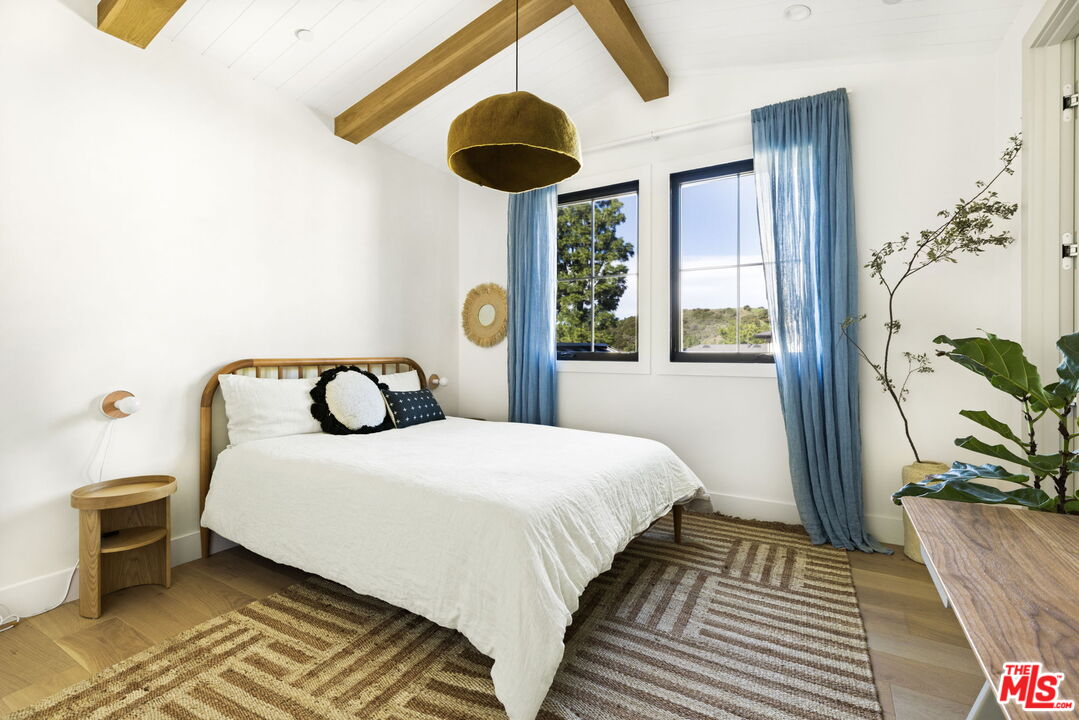 6310 Mirror Lake Drive Los Angeles, CA 90068 - Photo 23 of 34 a bedroom with a bed and a large mirror next to a window