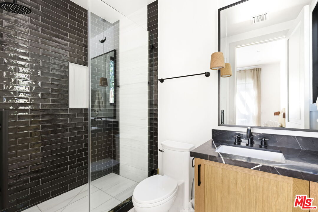 6310 Mirror Lake Drive Los Angeles, CA 90068 - Photo 26 of 34 a bathroom with a sink a toilet and shower