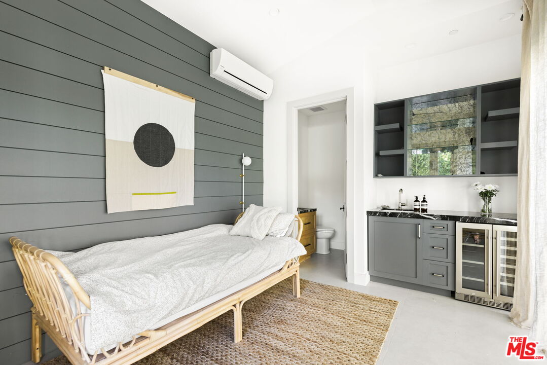 6310 Mirror Lake Drive Los Angeles, CA 90068 - Photo 32 of 34 a spacious bedroom with a bed and a flat screen tv