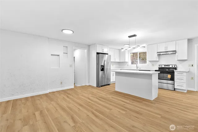 a view of kitchen with wooden floor