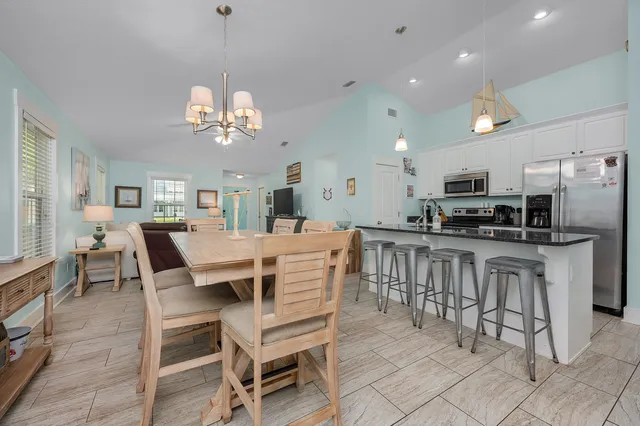 a view of a dining room with furniture and a chandelier