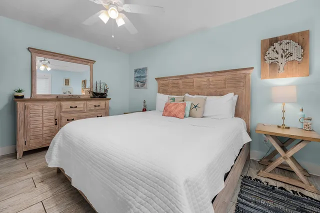 a bedroom with a large bed and a chandelier