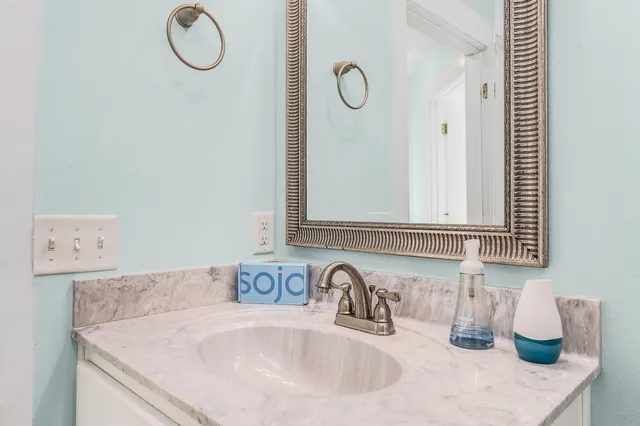 a bathroom with a sink and a mirror