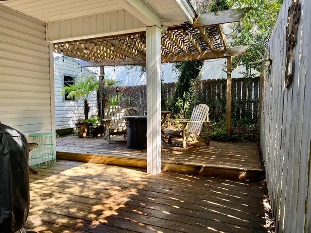 a view of a patio with a table and chairs and potted plants