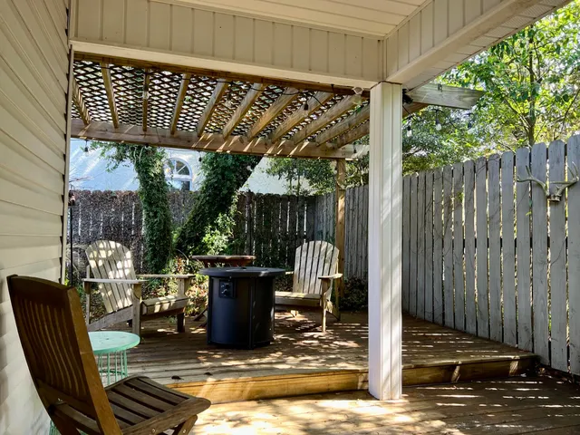 a view of balcony with wooden floor and outdoor seating