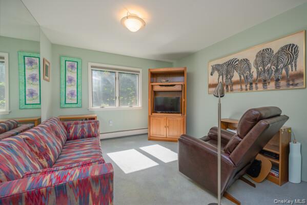 19 West Gate Road Suffern, NY 10901 - Photo 32 of 42 Inviting interior space featuring light green walls, a wall-mounted mirror, and carpet flooring