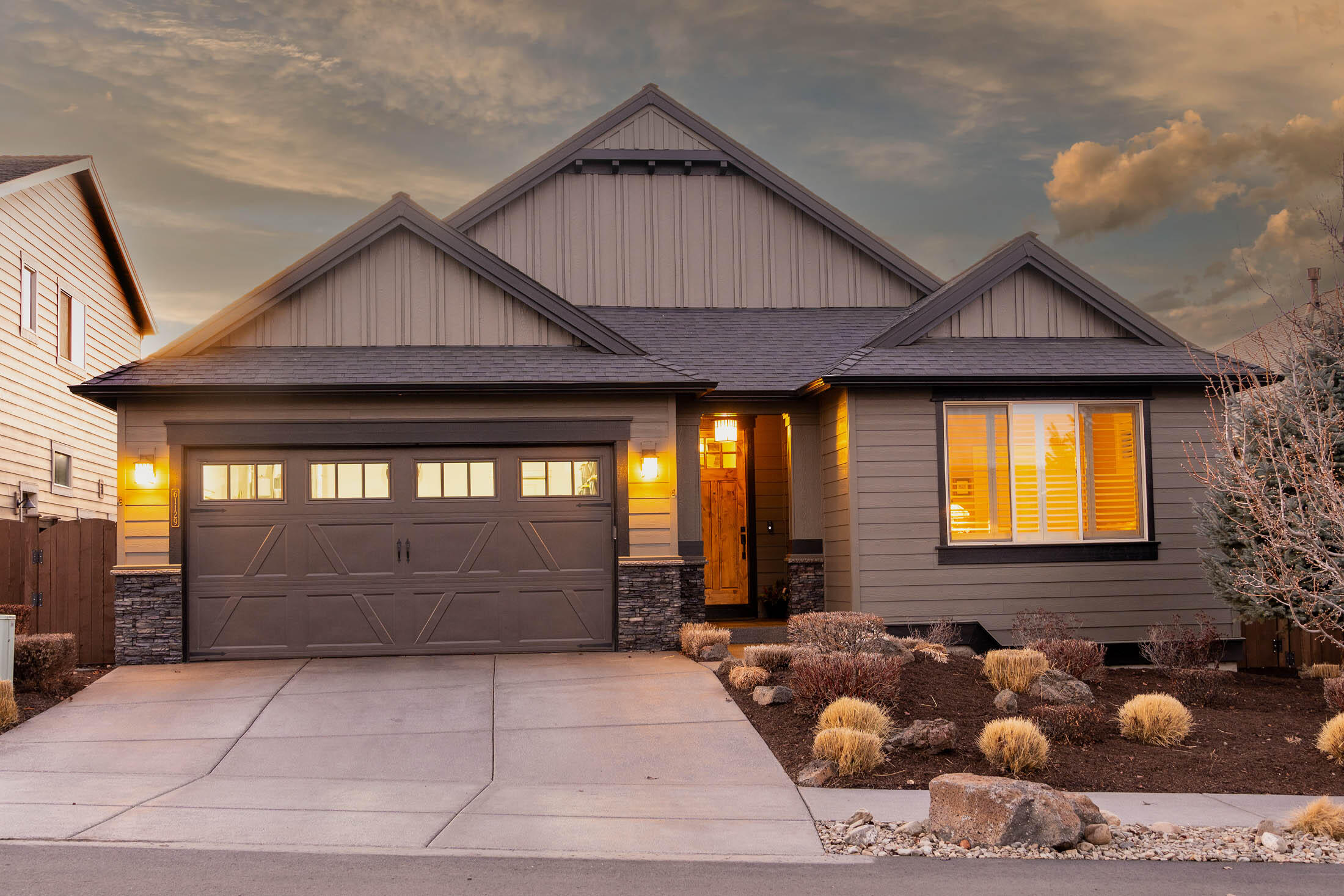 61129 Manhae Loop Bend, OR 97702 - Photo 44 of 44 Front exterior has stone masonry accents and exposed aggregate driveway and walk to covered front porch.