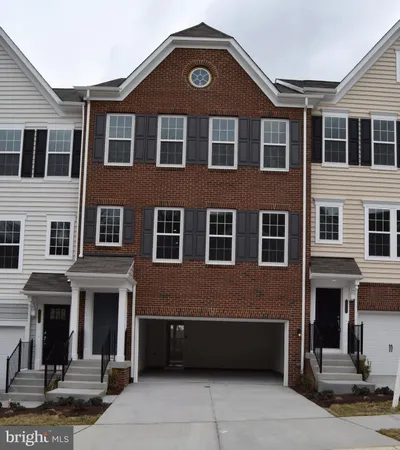 a front view of a building with a yard