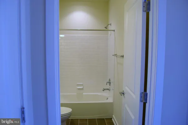 a view of a bathroom with a tub and mirror