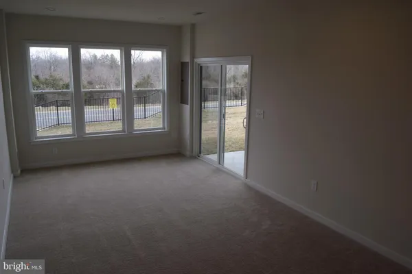 a view of a kitchen with white cabinets and a stove