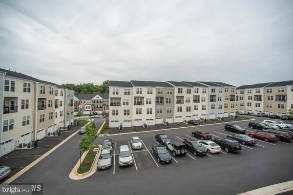 a view of a building with street and plants