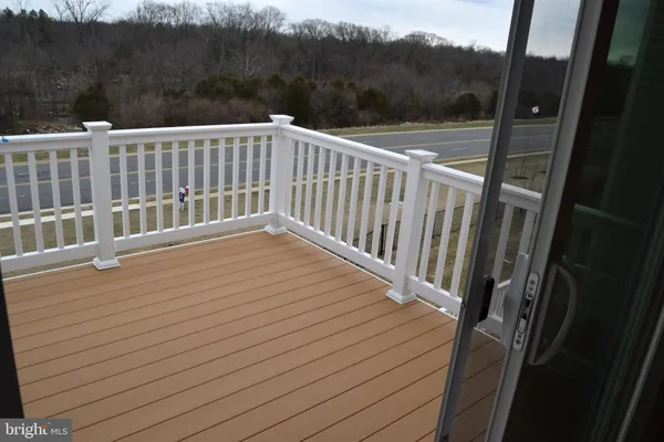 a view of a balcony with wooden floor