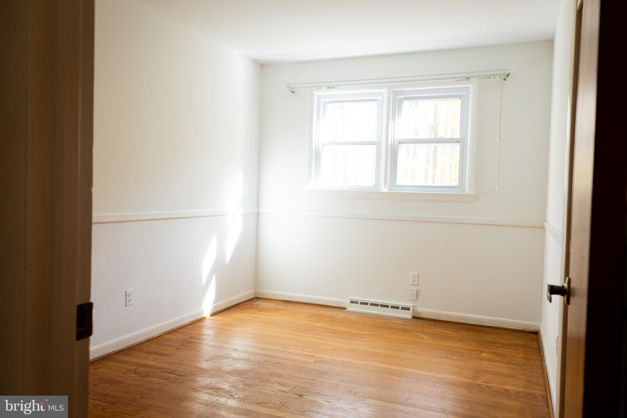 2720 Hidden Valley Road Accokeek, MD 20607 - Photo 19 of 43 an empty room with wooden floor and windows