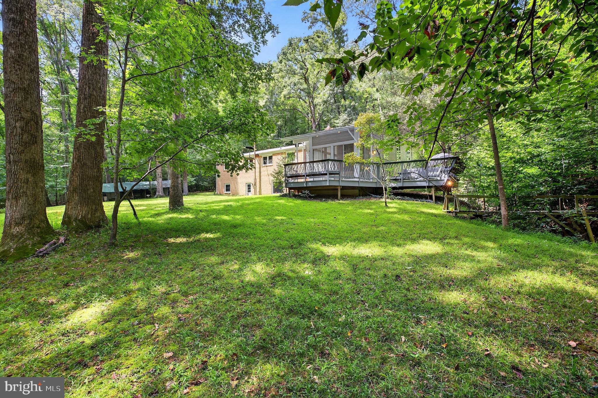 2720 Hidden Valley Road Accokeek, MD 20607 - Photo 2 of 43 a view of a house with a big yard potted plants and large tree