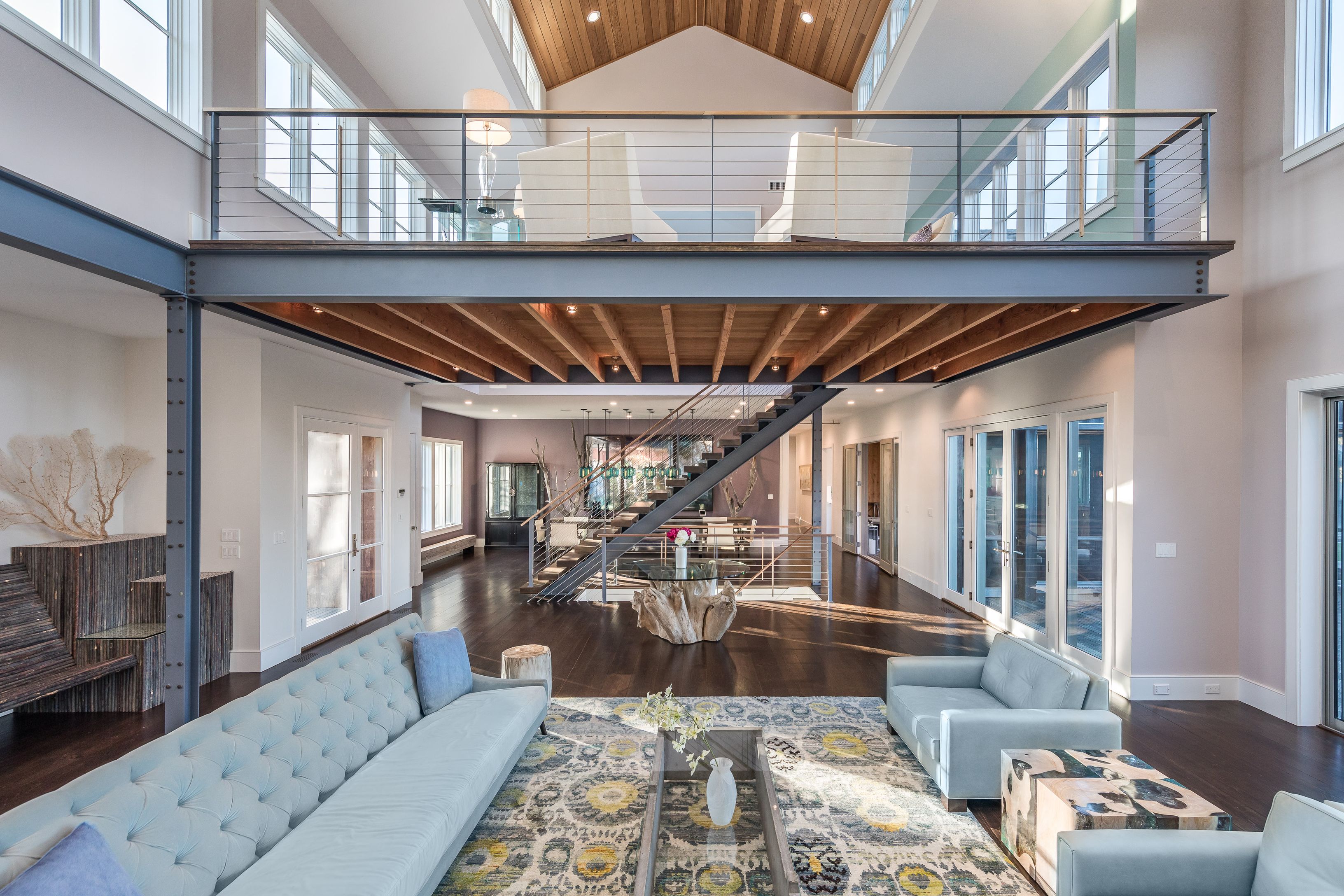 25 Jennifir Lane Bridgehampton, NY 11932 - Photo 11 of 44 a living room with furniture a rug and a chandelier