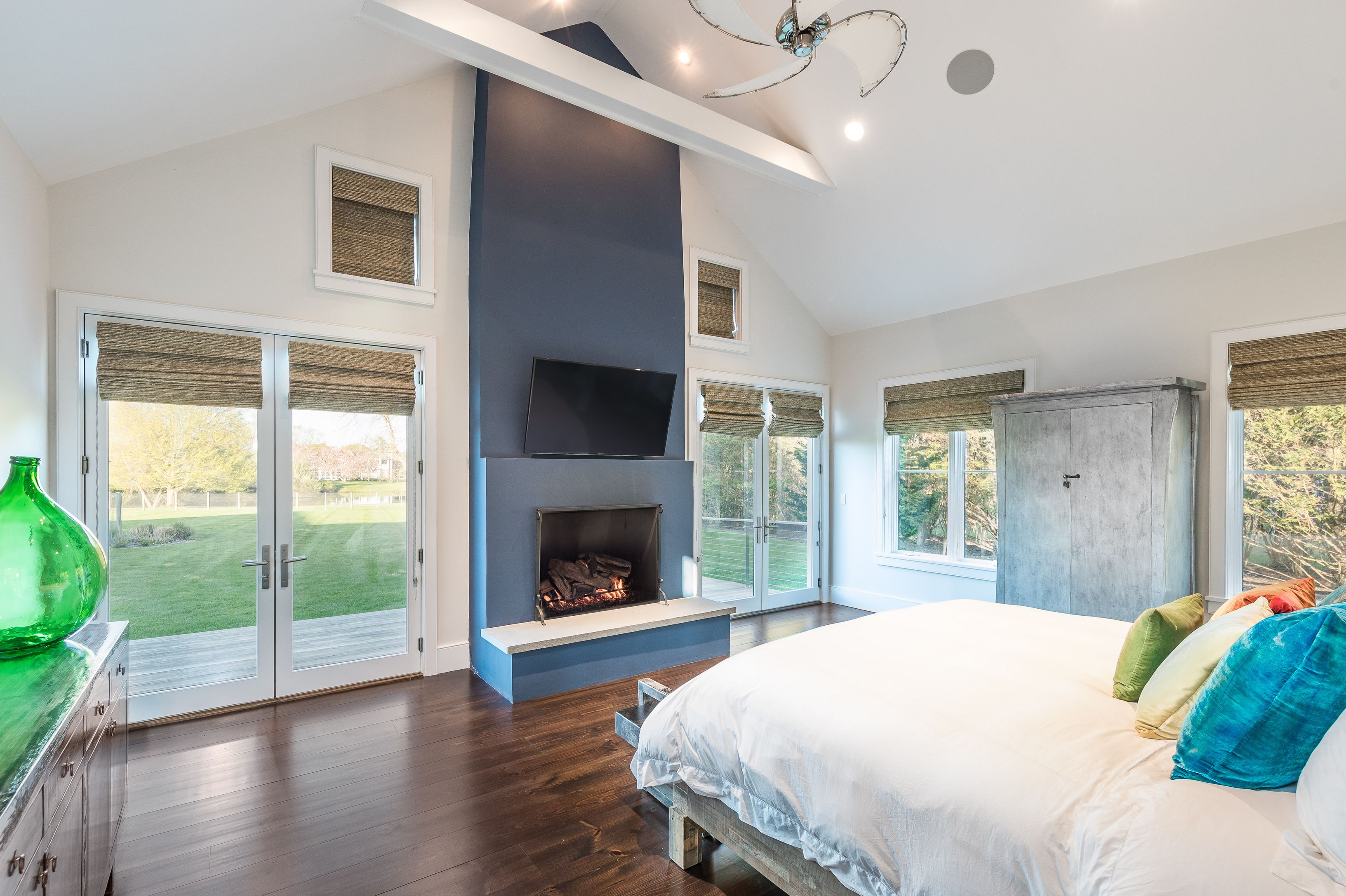 25 Jennifir Lane Bridgehampton, NY 11932 - Photo 32 of 44 a bedroom with a bed and a fireplace