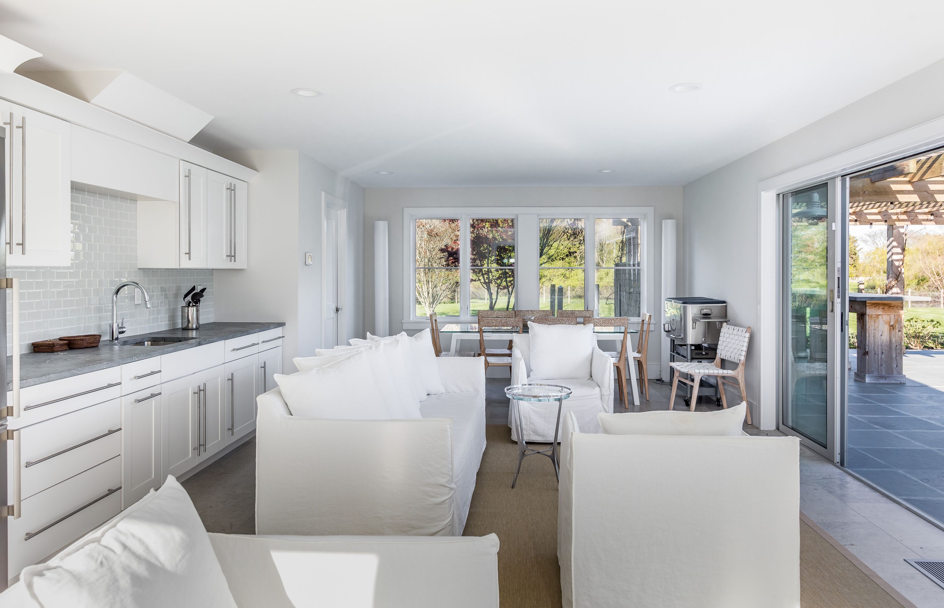 25 Jennifir Lane Bridgehampton, NY 11932 - Photo 40 of 44 a living room with kitchen island furniture and a large window