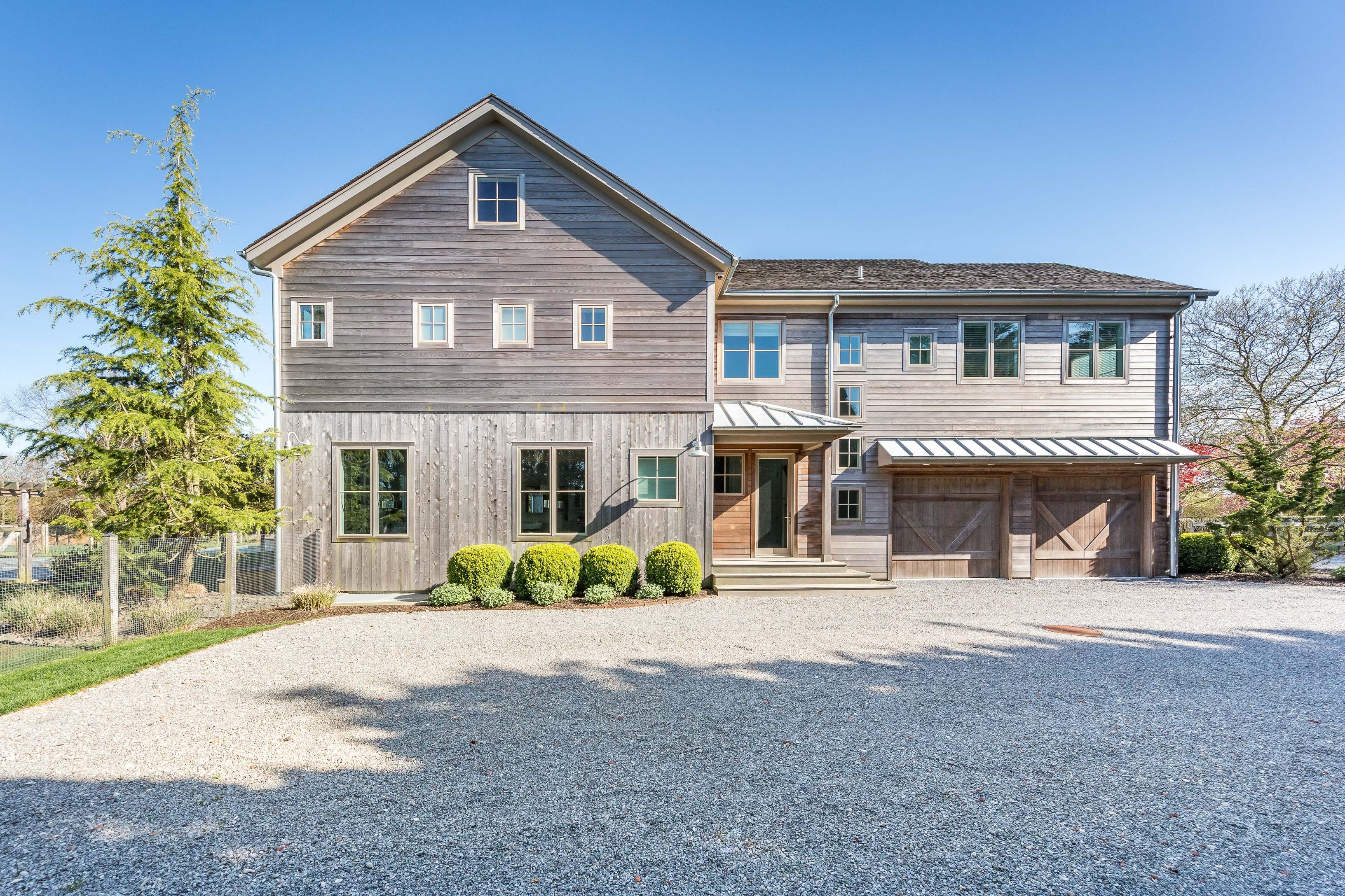 25 Jennifir Lane Bridgehampton, NY 11932 - Photo 5 of 44 a front view of a house with a yard