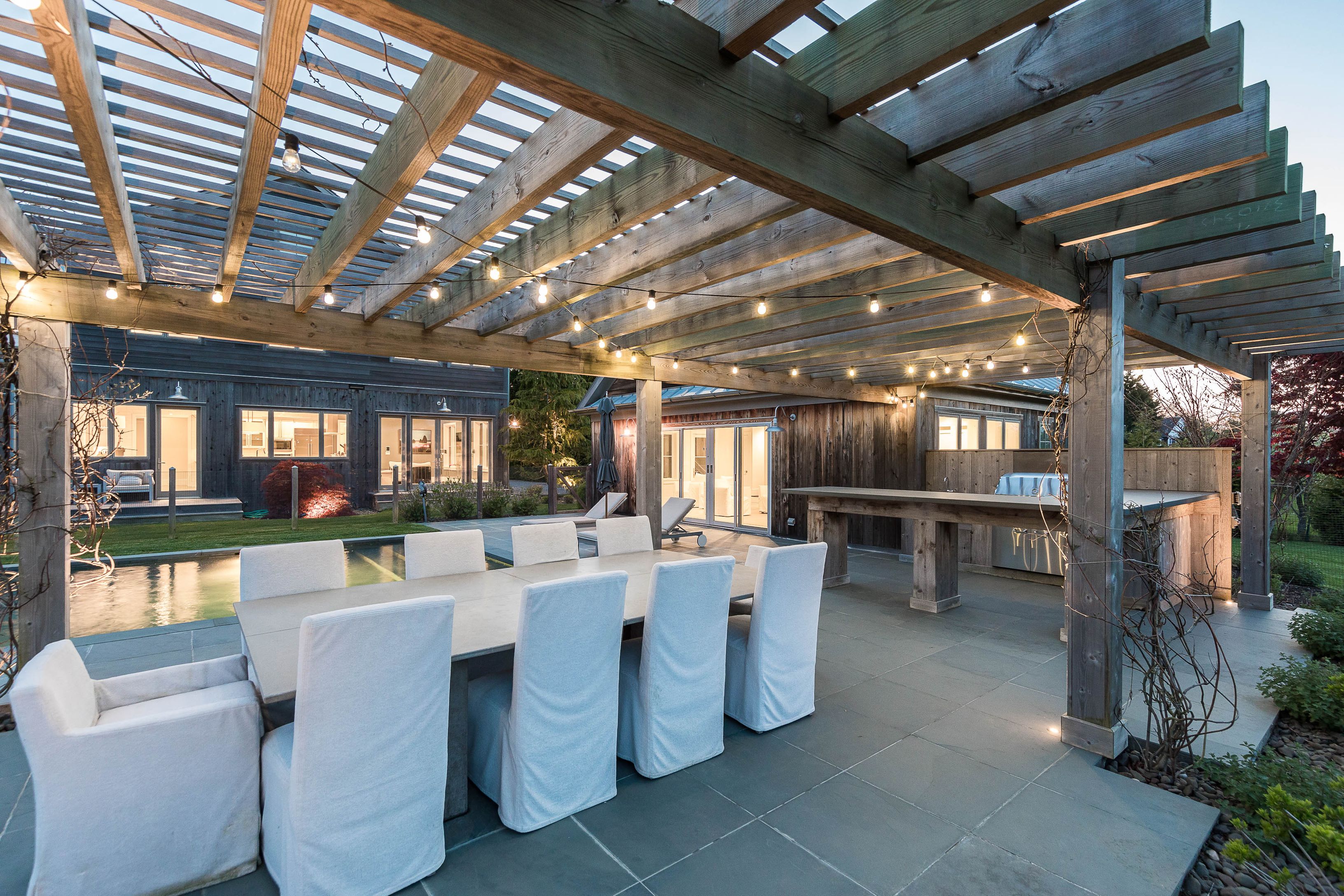 25 Jennifir Lane Bridgehampton, NY 11932 - Photo 10 of 44 a room with lots of tables a large window and chairs