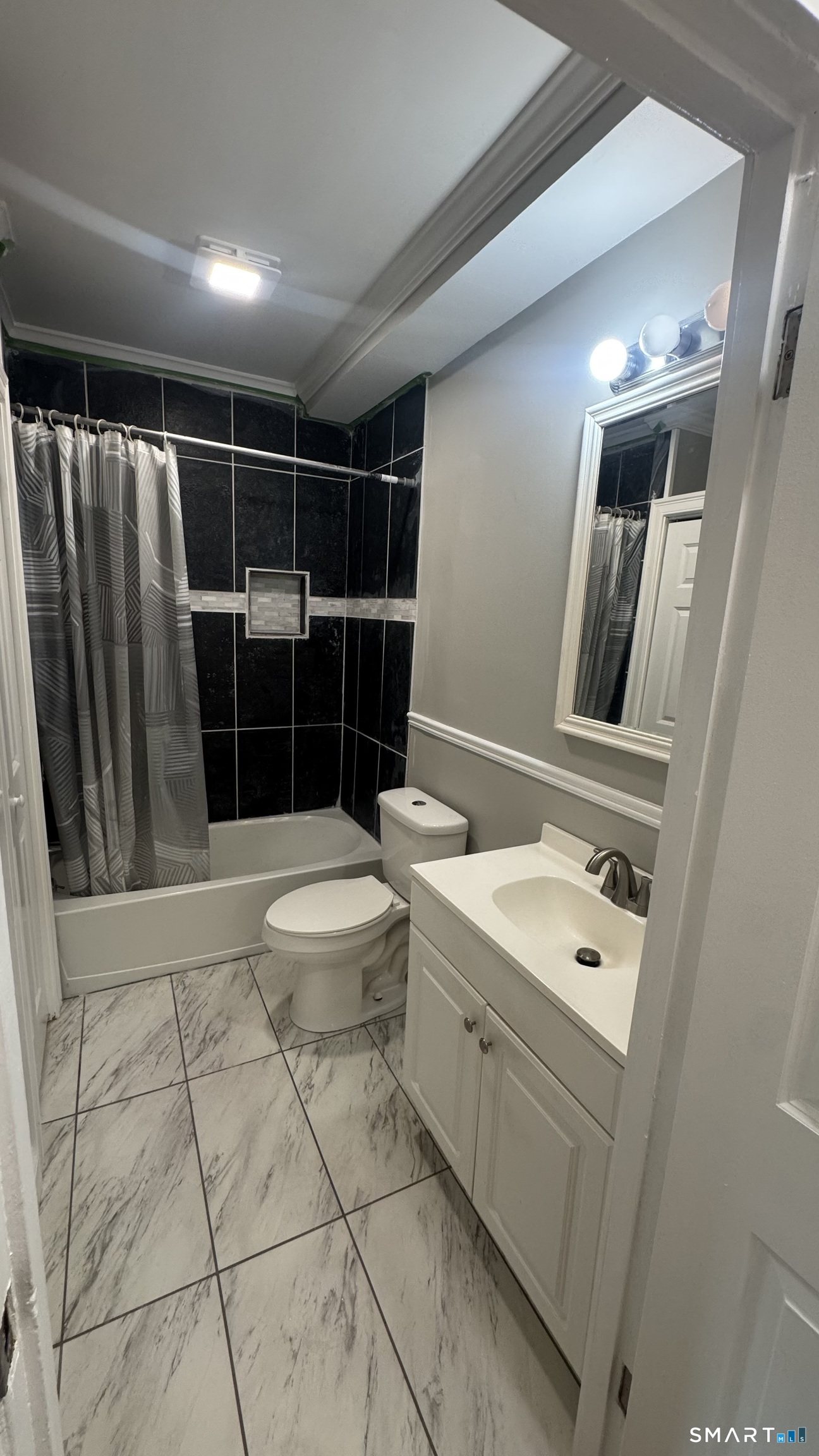104 Prospect Street Ansonia, CT 06401 - Photo 19 of 40 a bathroom with a toilet a sink a mirror and shower