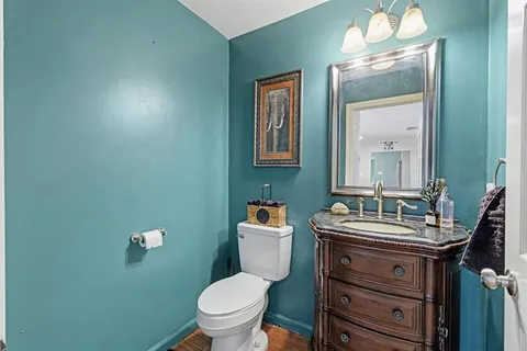 a bathroom with a toilet sink and mirror