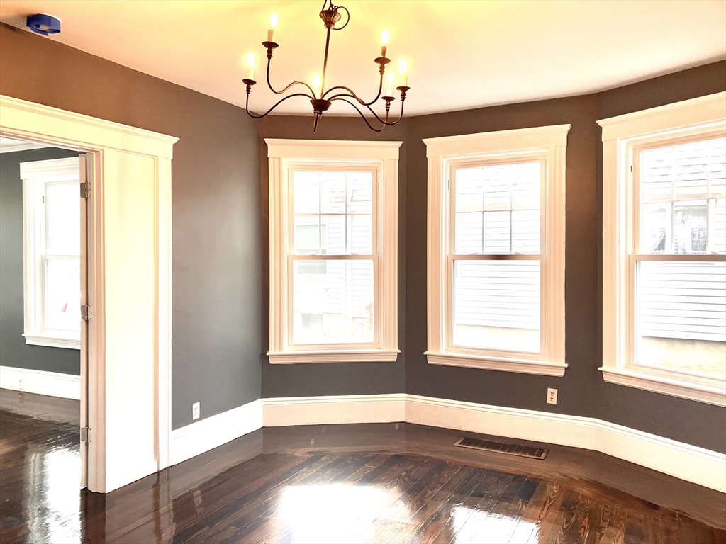 20 Sweetser Terrace, Unit 20 Lynn, MA 01904 - Photo 4 of 11 a view of an empty room with wooden floor and a window