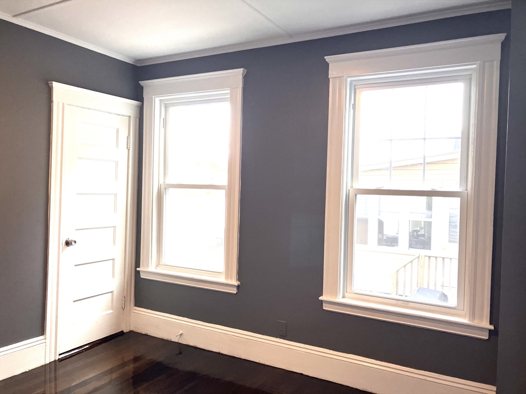 20 Sweetser Terrace, Unit 20 Lynn, MA 01904 - Photo 7 of 11 a view of an empty room with wooden floor and a window