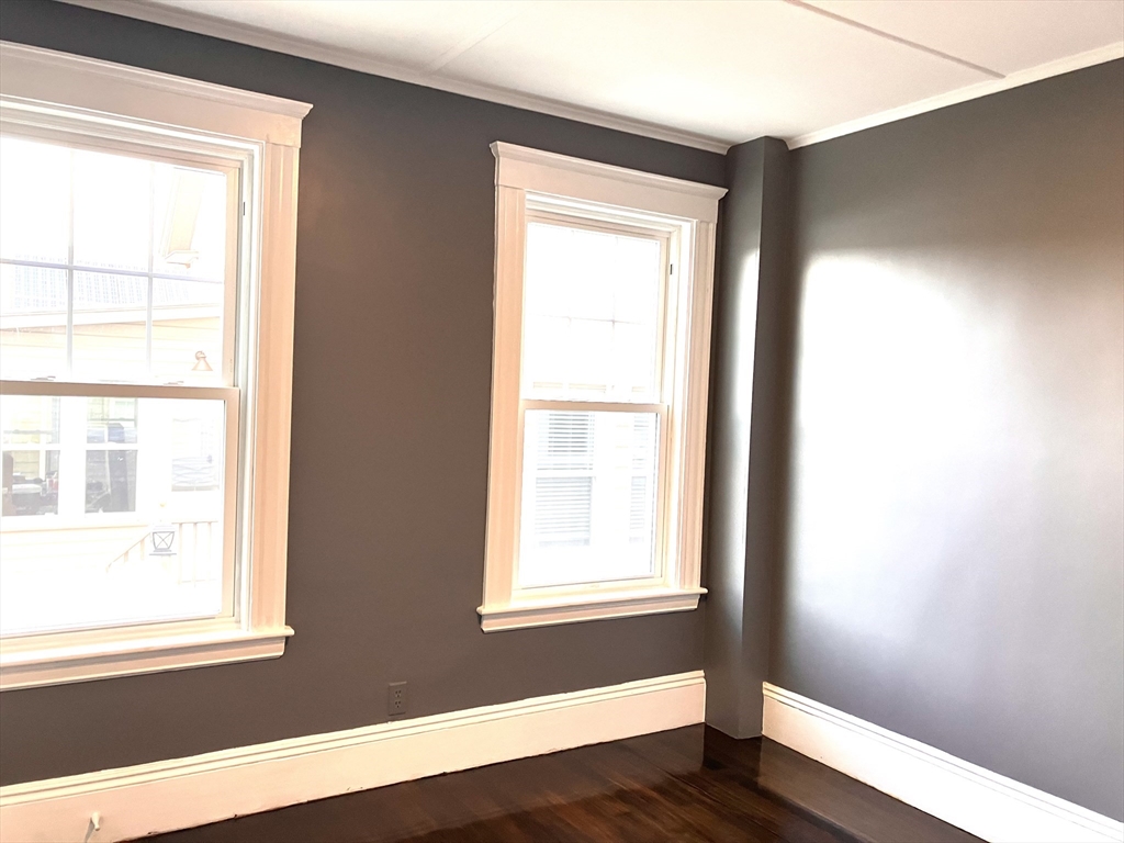 20 Sweetser Terrace, Unit 20 Lynn, MA 01904 - Photo 8 of 11 a view of an empty room with wooden floor and a window