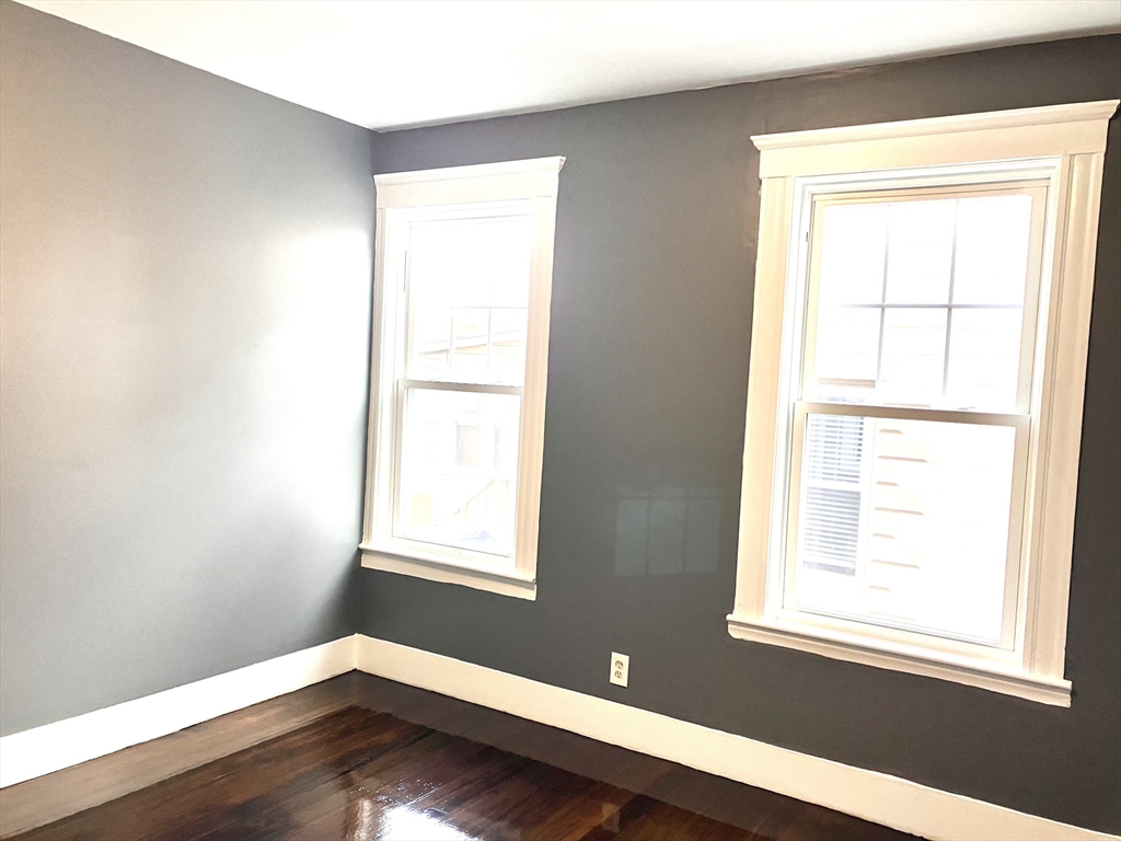 20 Sweetser Terrace, Unit 20 Lynn, MA 01904 - Photo 9 of 11 a view of an empty room with wooden floor and a window