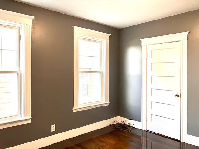 a room with a window and wooden floor