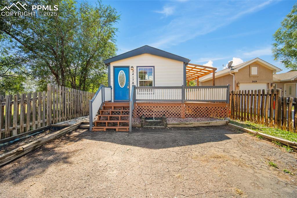 2417 West Cache La Poudre Street, Unit A & B Colorado Springs, CO 80904 - Photo 1 of 38 a view of a house with wooden floor roof and wooden fence