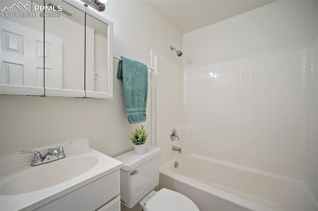 2417 West Cache La Poudre Street, Unit A & B Colorado Springs, CO 80904 - Photo 11 of 38 a bathroom with a sink a toilet and shower