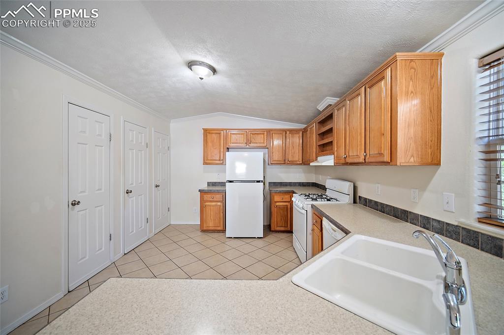 2417 West Cache La Poudre Street, Unit A & B Colorado Springs, CO 80904 - Photo 12 of 38 a kitchen that has a sink and a stove in it