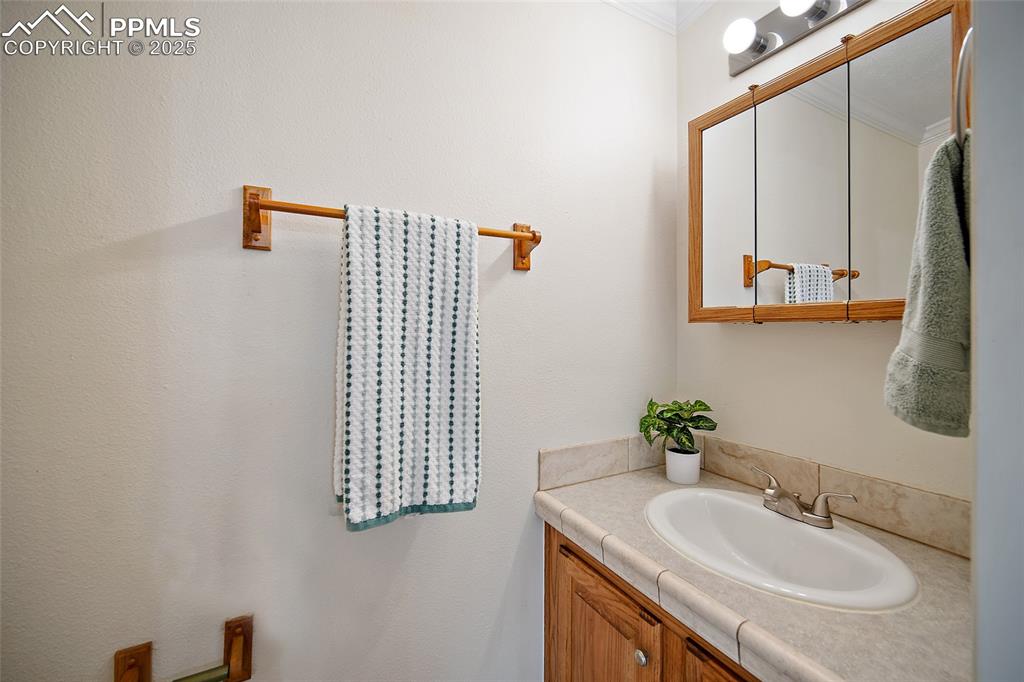 2417 West Cache La Poudre Street, Unit A & B Colorado Springs, CO 80904 - Photo 14 of 38 a bathroom with a sink and a mirror