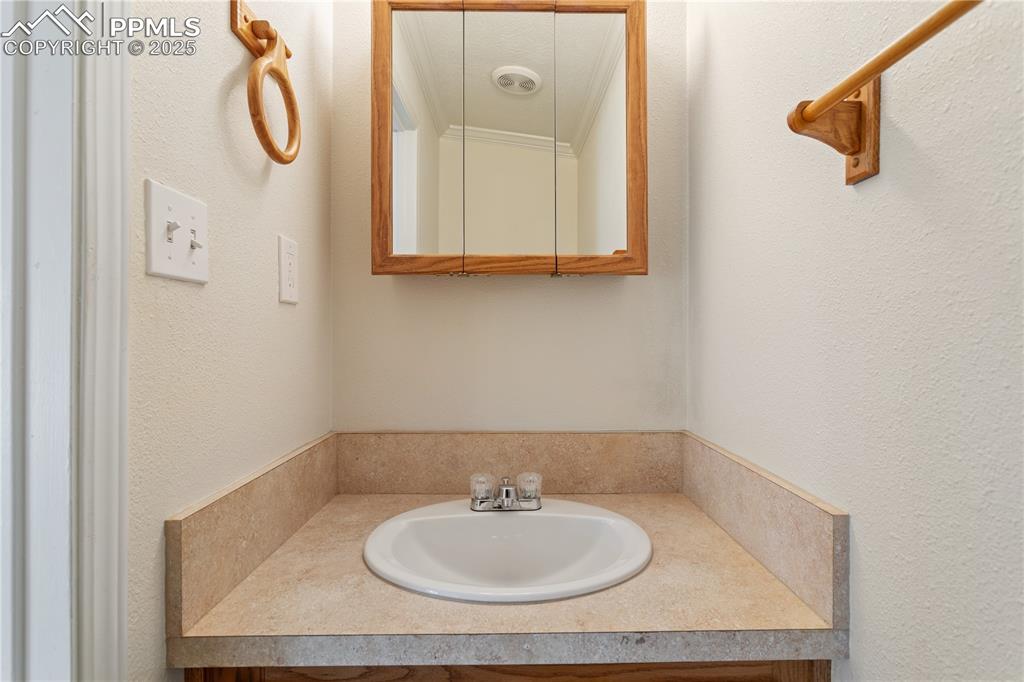2417 West Cache La Poudre Street, Unit A & B Colorado Springs, CO 80904 - Photo 31 of 38 a bathroom with a sink and a mirror