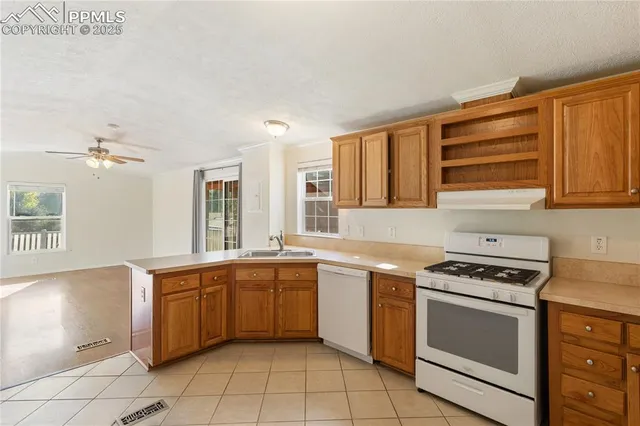 a kitchen with a stove sink and cabinets