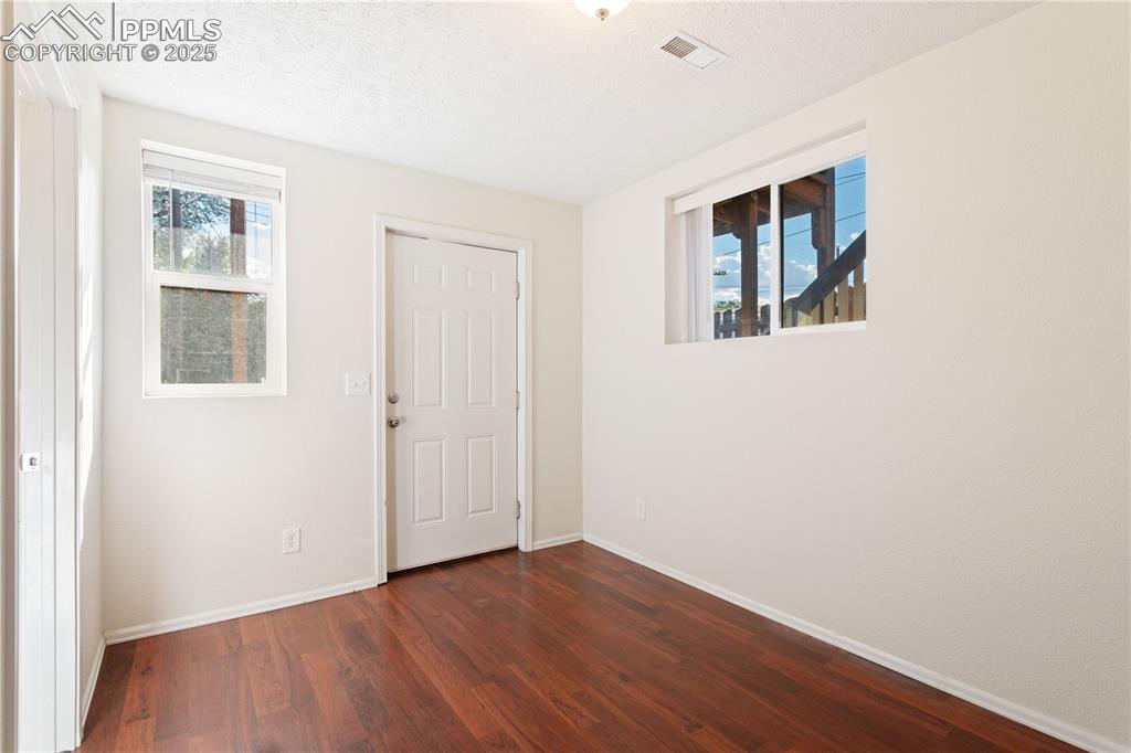2417 West Cache La Poudre Street, Unit A & B Colorado Springs, CO 80904 - Photo 37 of 38 a view of an empty room with wooden floor and a window