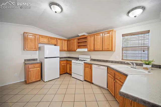 a kitchen with refrigerator cabinets and a sink