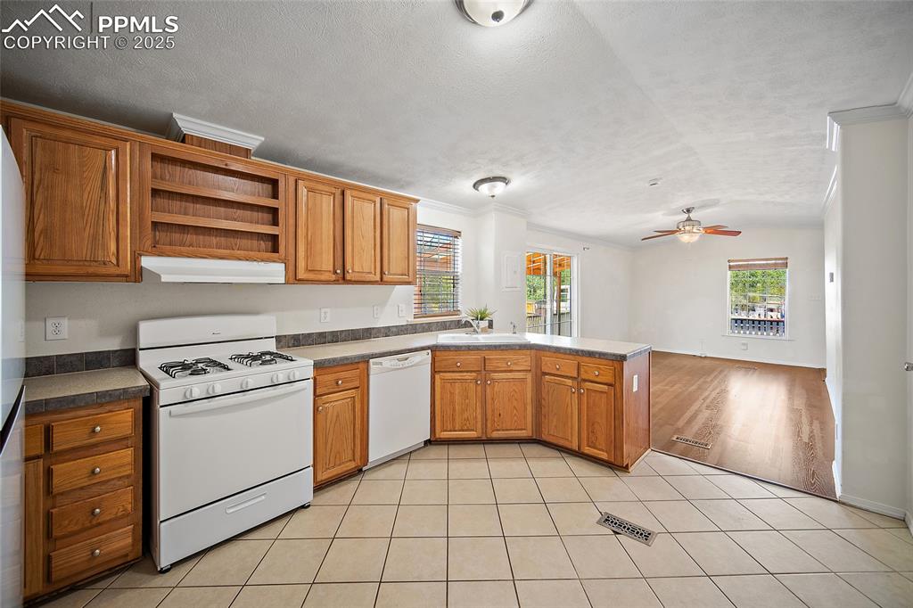 2417 West Cache La Poudre Street, Unit A & B Colorado Springs, CO 80904 - Photo 8 of 38 a kitchen with a stove a sink and a refrigerator