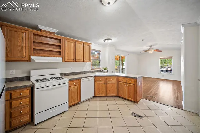 a kitchen with a stove a sink and a refrigerator
