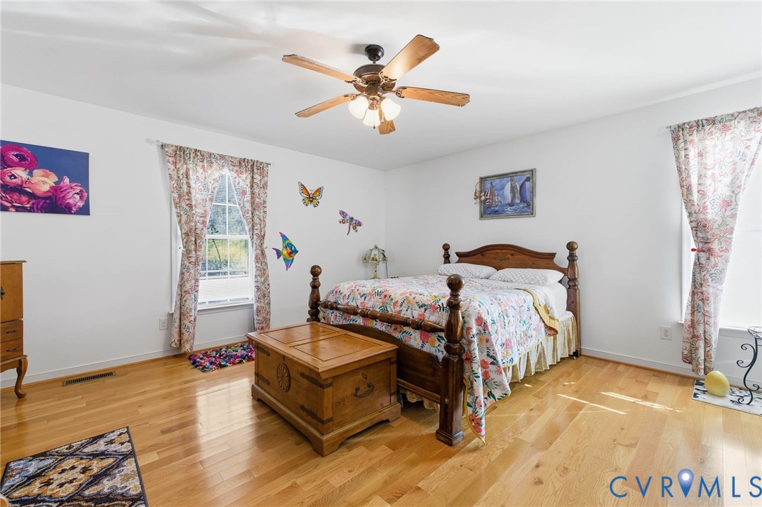 15900 Nobles Road Disputanta, VA 23842 - Photo 18 of 36 Bedroom with light hardwood flooring and ceiling f