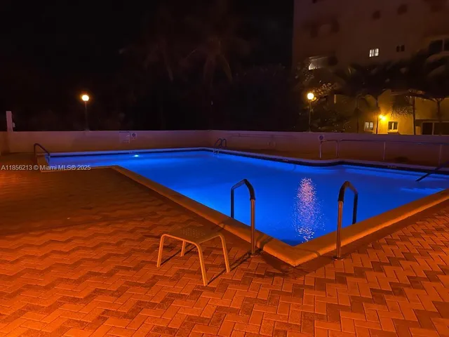 a view of a patio with table and chairs under an umbrella