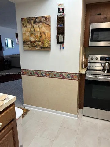 a kitchen with stainless steel appliances granite countertop a sink a stove and cabinets