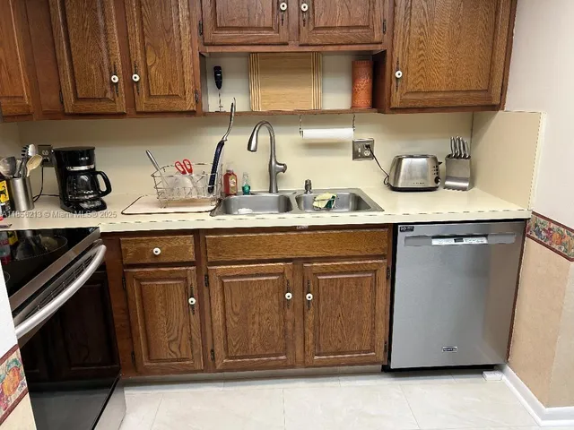 a kitchen with sink a microwave and stove