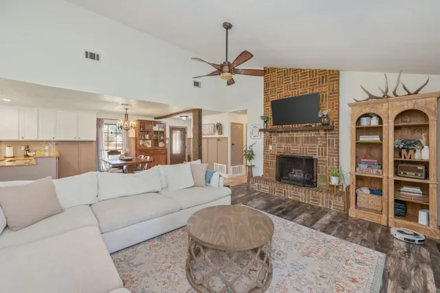a living room with fireplace and furniture