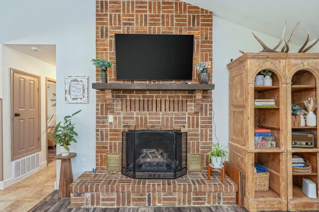 a view of a dining room with furniture and chandelier
