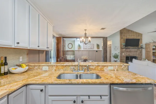 a kitchen with granite countertop a stove and a microwave